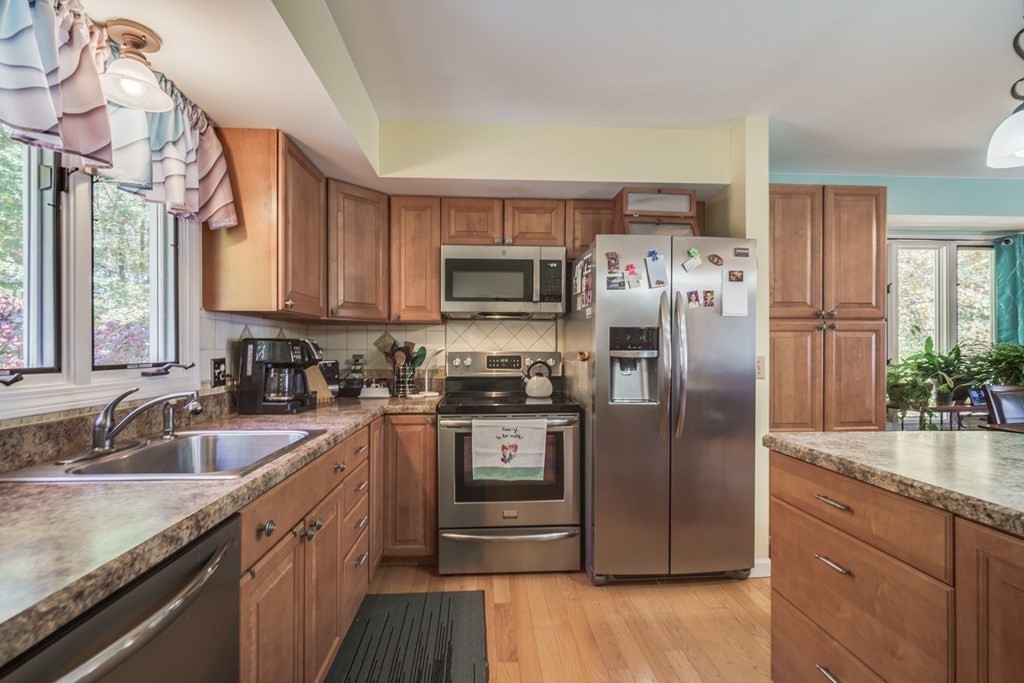 610 County Road, Unit 5 Holyoke, MA 01040 - Photo 7 of 33 a kitchen with stainless steel appliances granite countertop a refrigerator a sink a stove and cabinets
