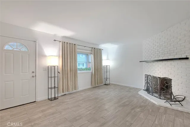 a view of a livingroom with a wooden floor and a fireplace