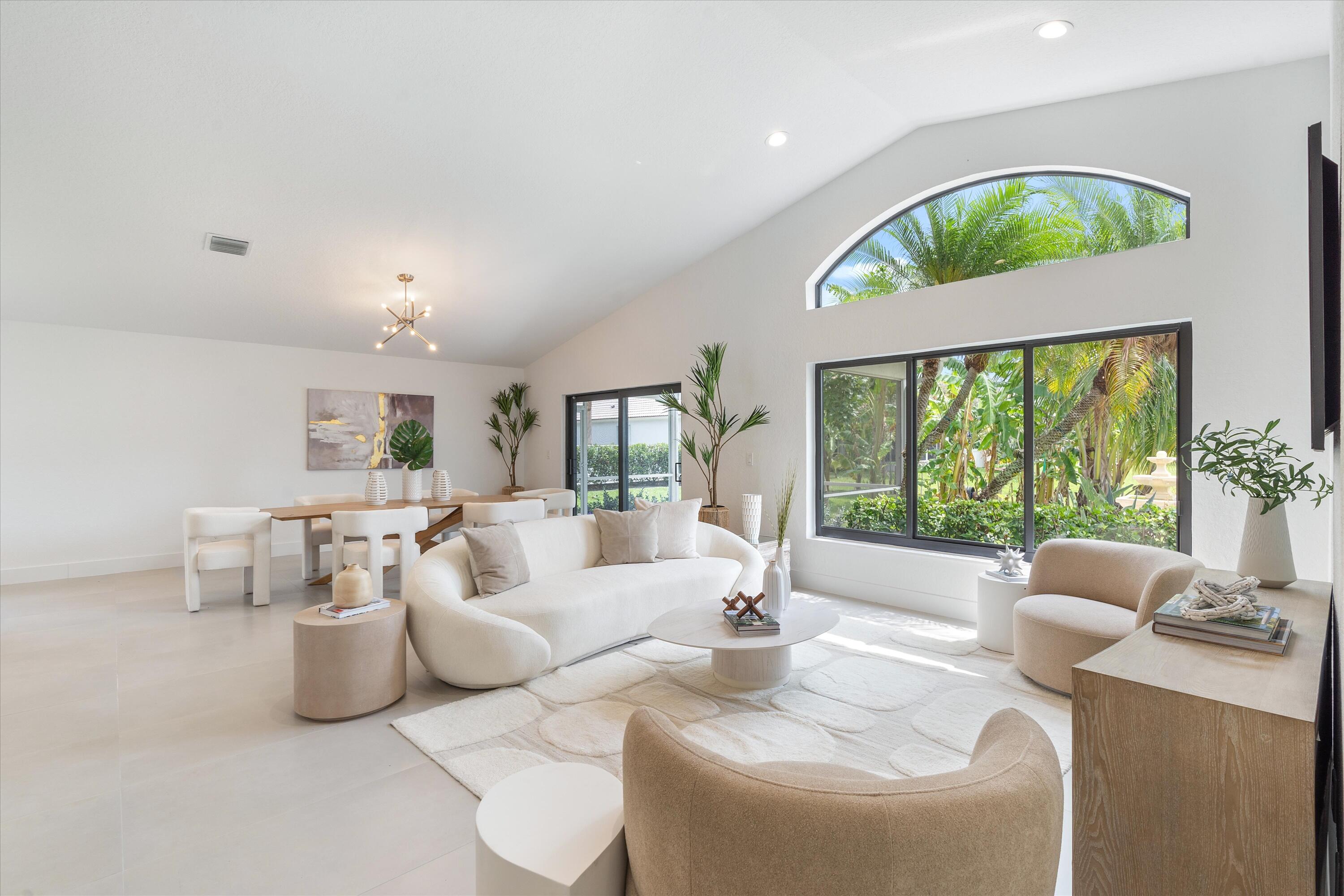1175 Sea Grape Circle Delray Beach, FL 33445 - Photo 13 of 42 a living room with furniture and a large window