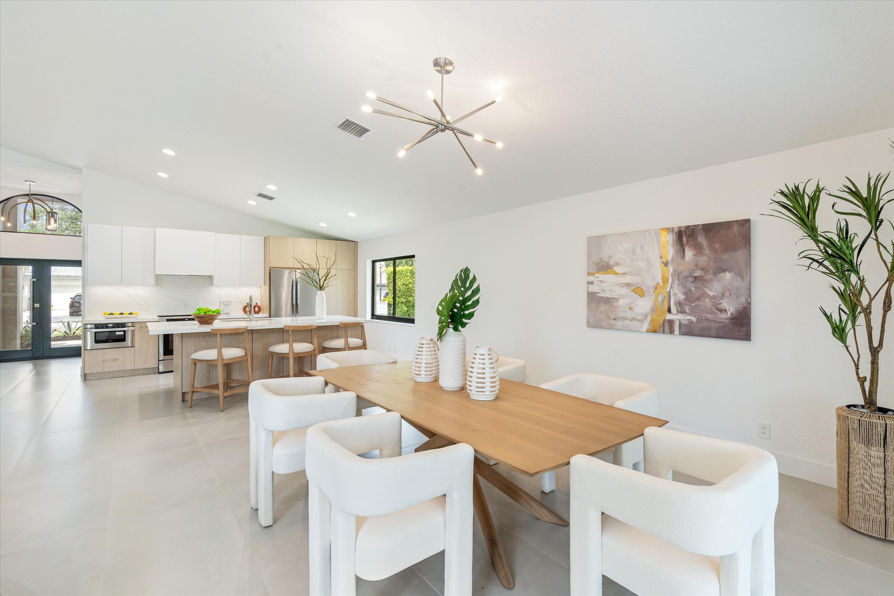 1175 Sea Grape Circle Delray Beach, FL 33445 - Photo 16 of 42 a view of a dining room with furniture and a livingroom