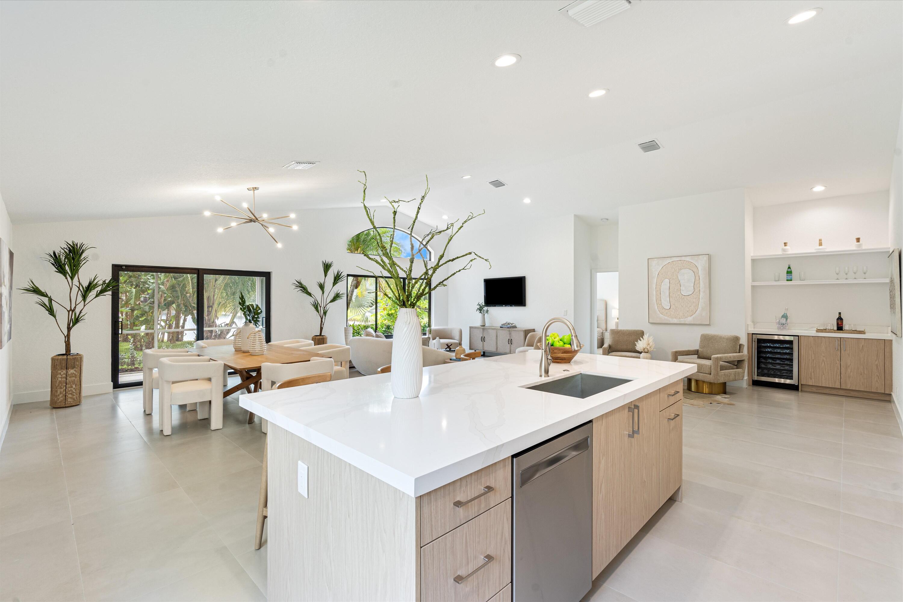 1175 Sea Grape Circle Delray Beach, FL 33445 - Photo 18 of 42 a kitchen with sink and white cabinets
