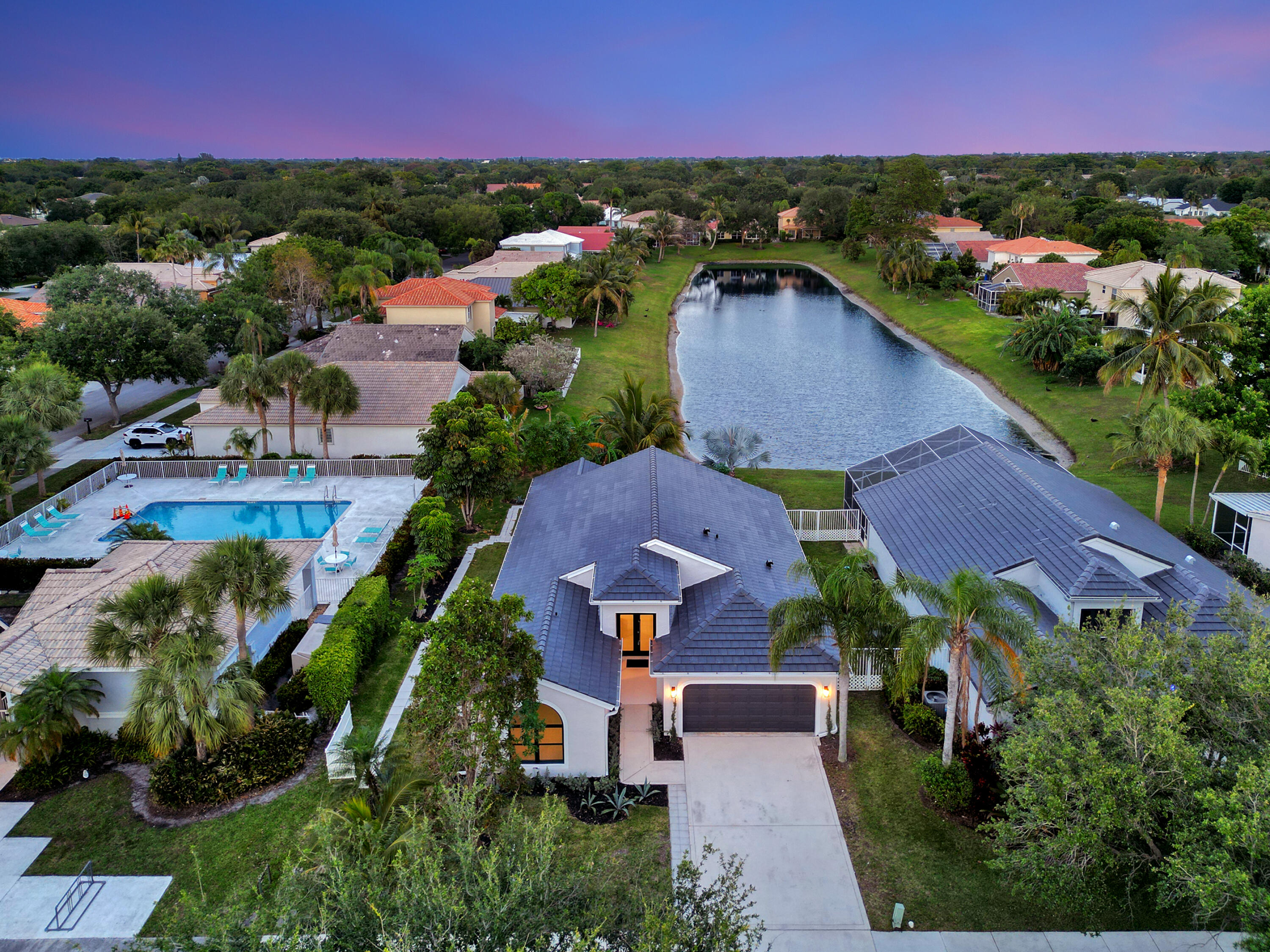 1175 Sea Grape Circle Delray Beach, FL 33445 - Photo 2 of 42 an aerial view of a house with a garden and lake view
