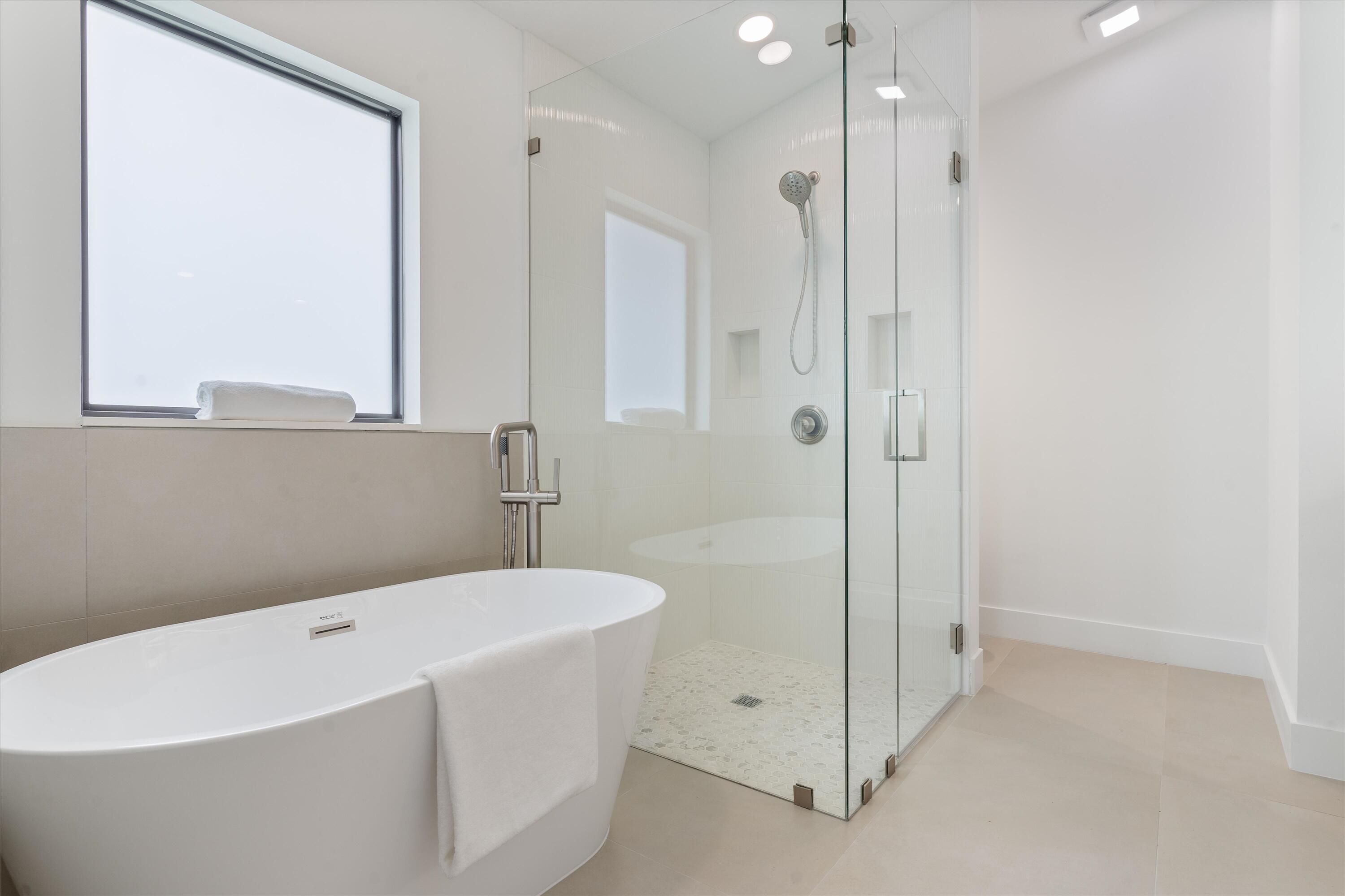 1175 Sea Grape Circle Delray Beach, FL 33445 - Photo 24 of 42 a bathroom with a bathtub and a shower