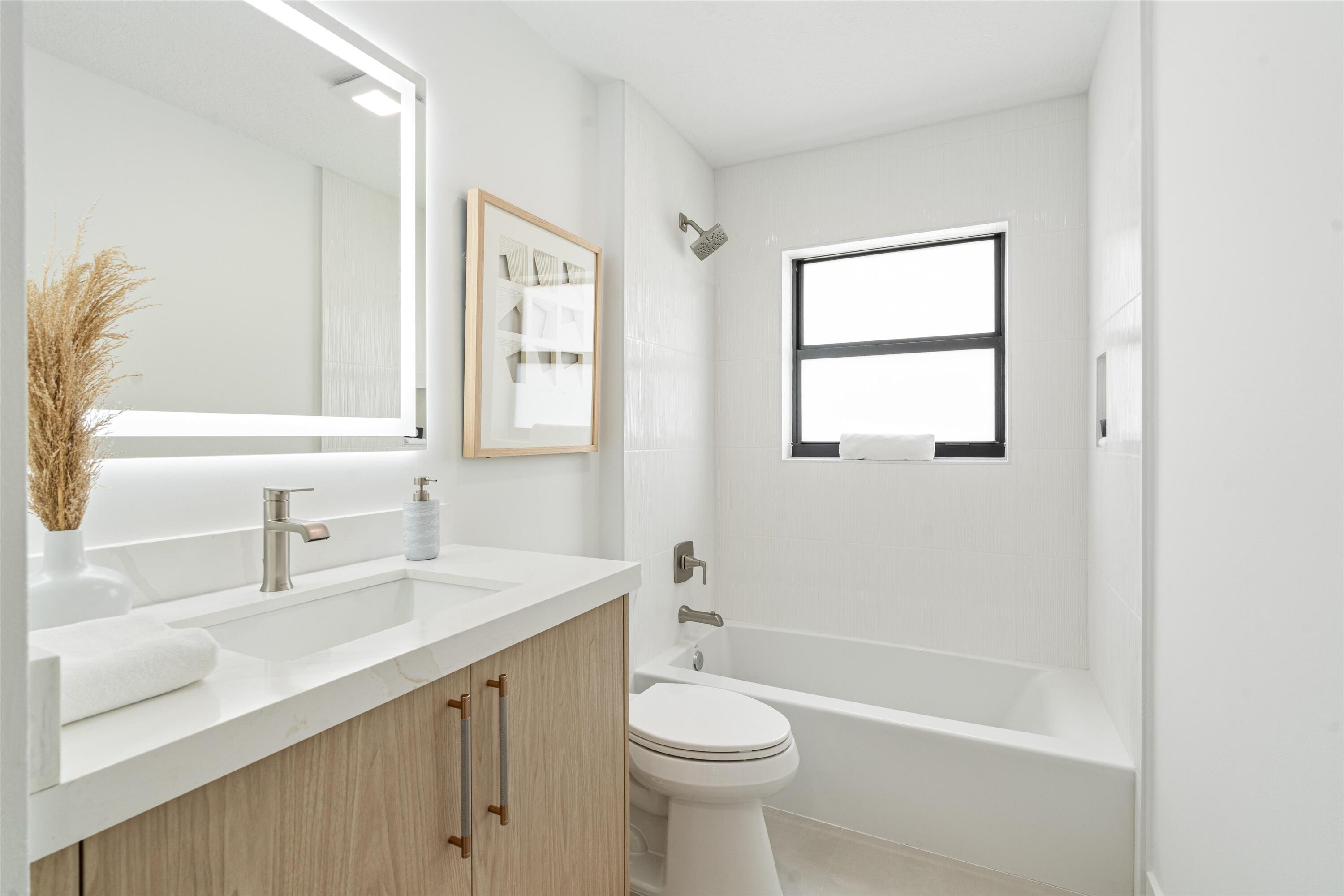 1175 Sea Grape Circle Delray Beach, FL 33445 - Photo 30 of 42 a bathroom with a sink a toilet and shower