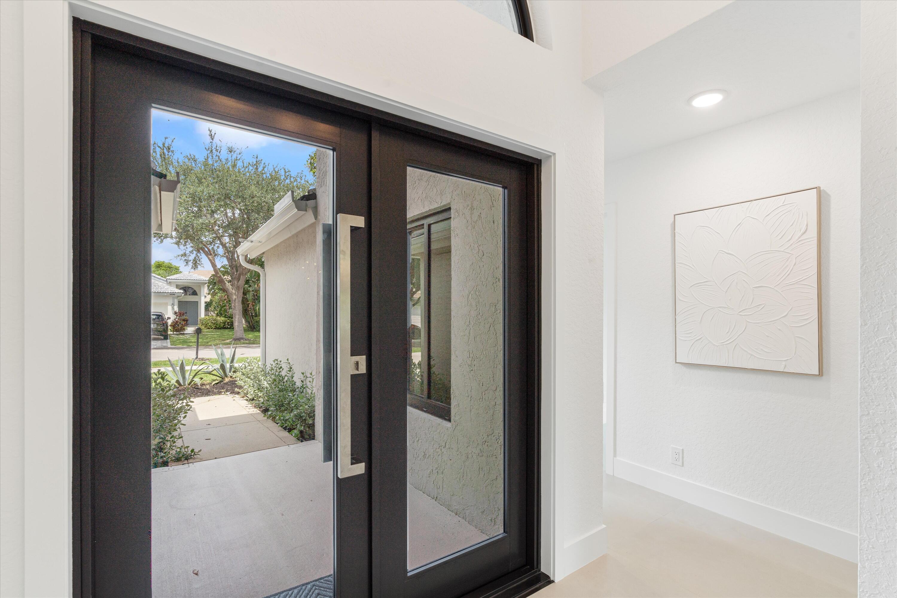 1175 Sea Grape Circle Delray Beach, FL 33445 - Photo 6 of 42 a view of a glass door and a living room