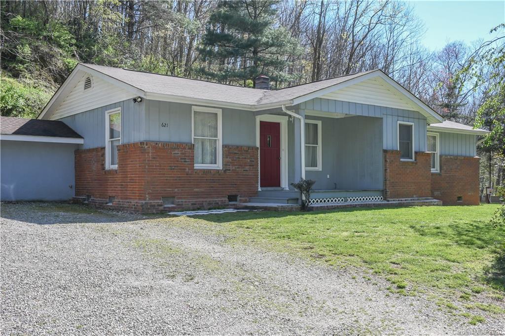 621 Incinerator Road Clyde, NC 28721 - Photo 1 of 27 a front view of a house with a yard and garage