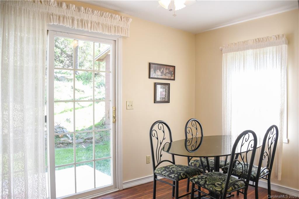 621 Incinerator Road Clyde, NC 28721 - Photo 16 of 27 a view of a dining room with furniture window and wooden floor