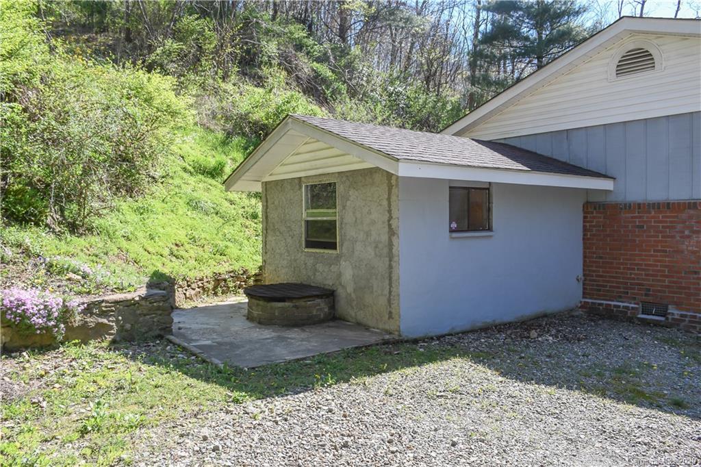 621 Incinerator Road Clyde, NC 28721 - Photo 21 of 27 a view of a backyard with plants and large tree