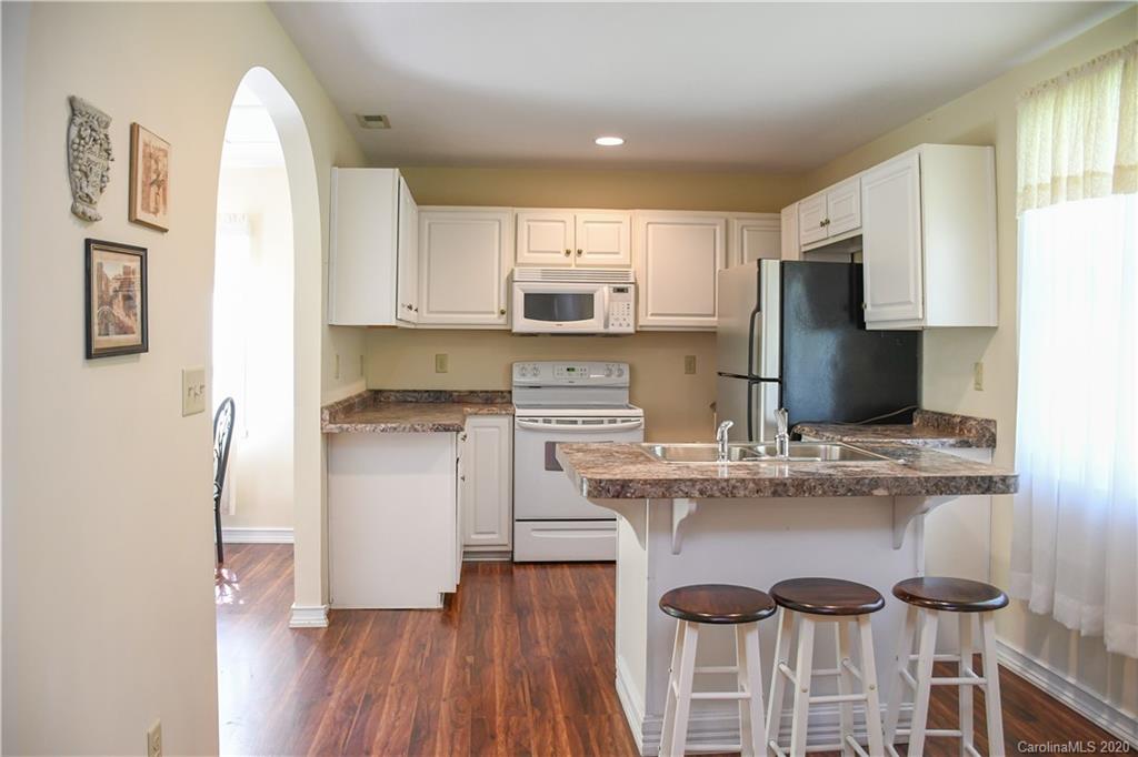 621 Incinerator Road Clyde, NC 28721 - Photo 4 of 27 a kitchen with kitchen island granite countertop a sink cabinets and wooden floor