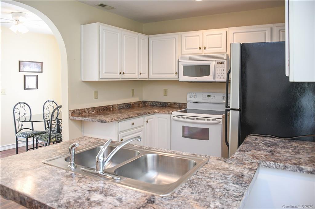 621 Incinerator Road Clyde, NC 28721 - Photo 6 of 27 a kitchen with granite countertop a sink cabinets and stainless steel appliances