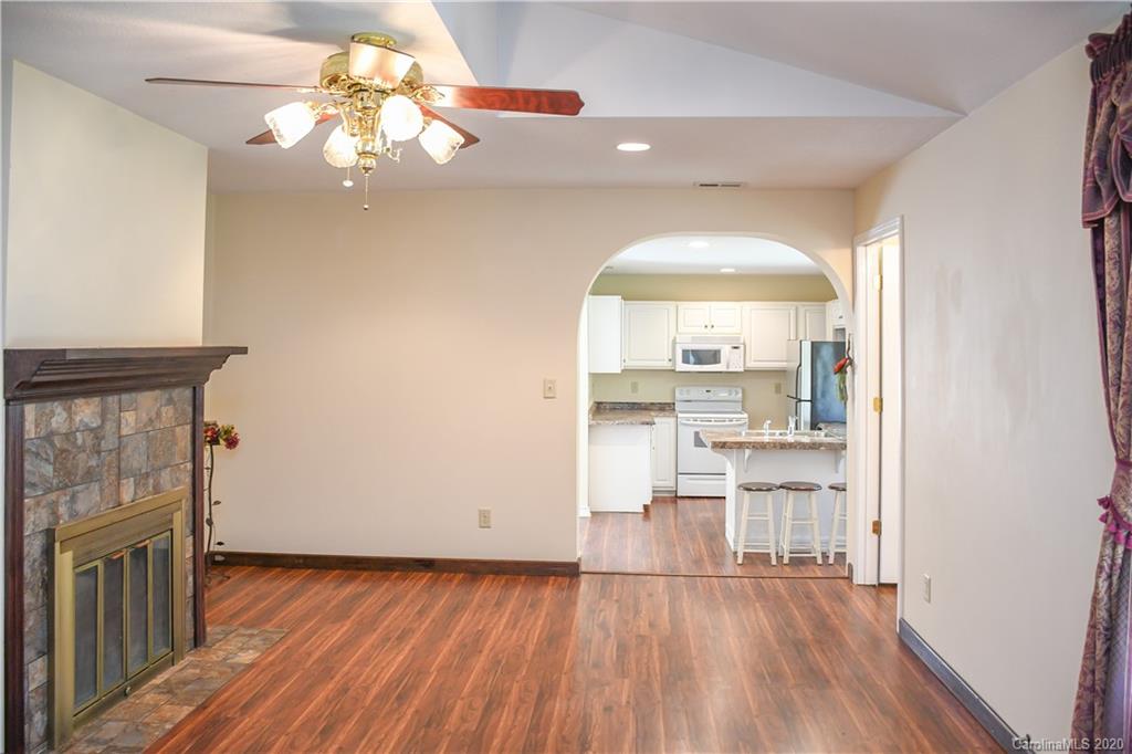 621 Incinerator Road Clyde, NC 28721 - Photo 7 of 27 a view of a livingroom with wooden floor and a kitchen