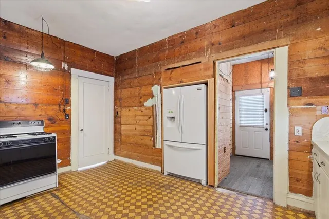 a kitchen with a refrigerator and a stove