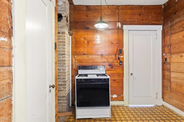 a bathroom with a stove and a shower