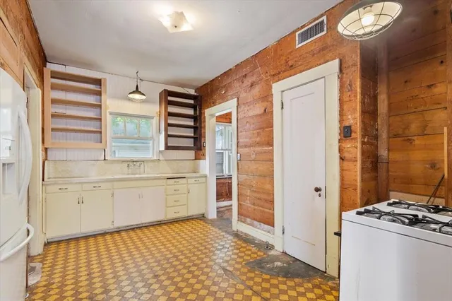 a bathroom with a granite countertop sink a toilet and a shower