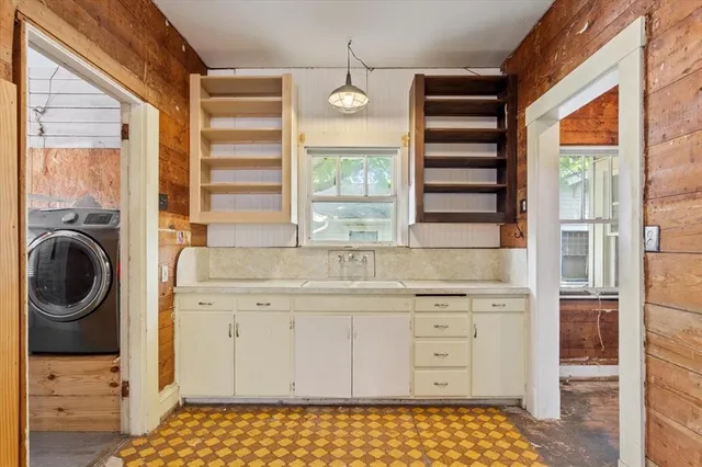 a kitchen with a cabinets and a stove top oven