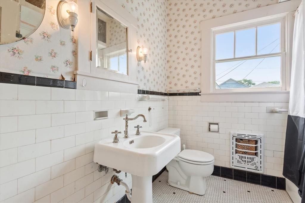 2600 Colcord Avenue Waco, TX 76707 - Photo 24 of 37 a bathroom with a toilet sink and mirror