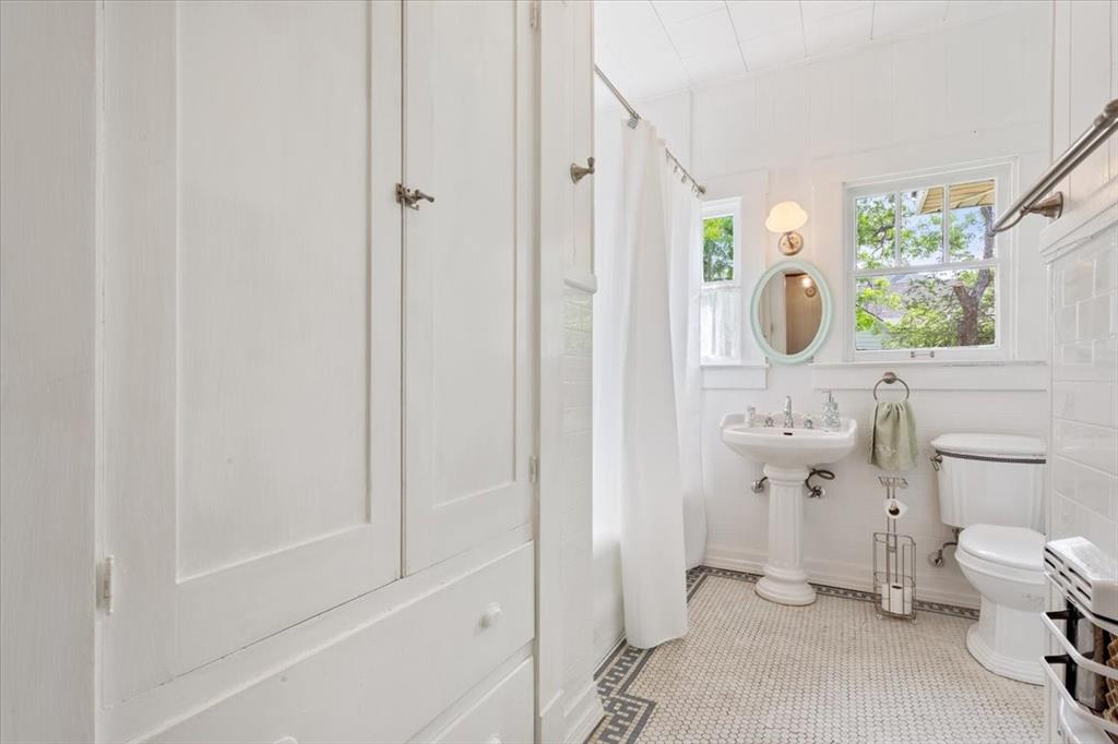 2600 Colcord Avenue Waco, TX 76707 - Photo 25 of 37 a bathroom with a sink a toilet and a mirror