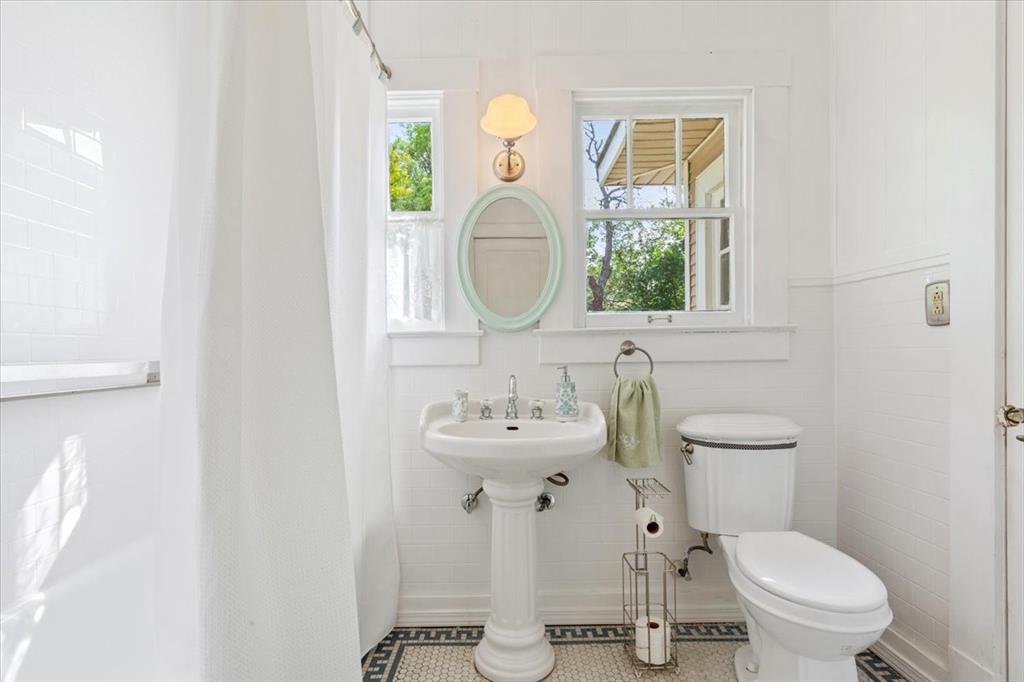 2600 Colcord Avenue Waco, TX 76707 - Photo 26 of 37 a bathroom with a toilet sink and mirror