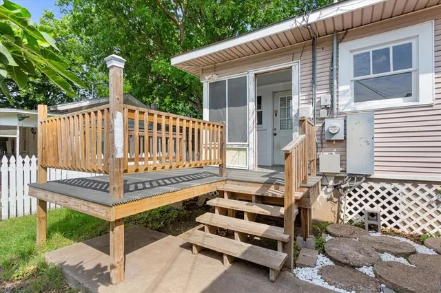 a view of a bench in wooden deck