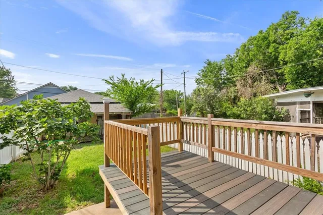 a view of balcony with wooden floor and fence