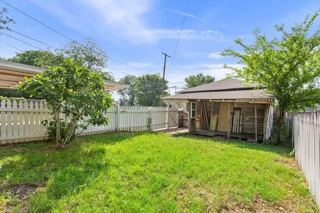 a view of a house with a yard and sitting area