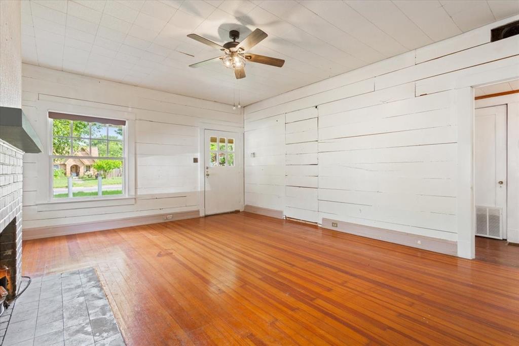 2600 Colcord Avenue Waco, TX 76707 - Photo 5 of 37 an empty room with wooden floor and windows