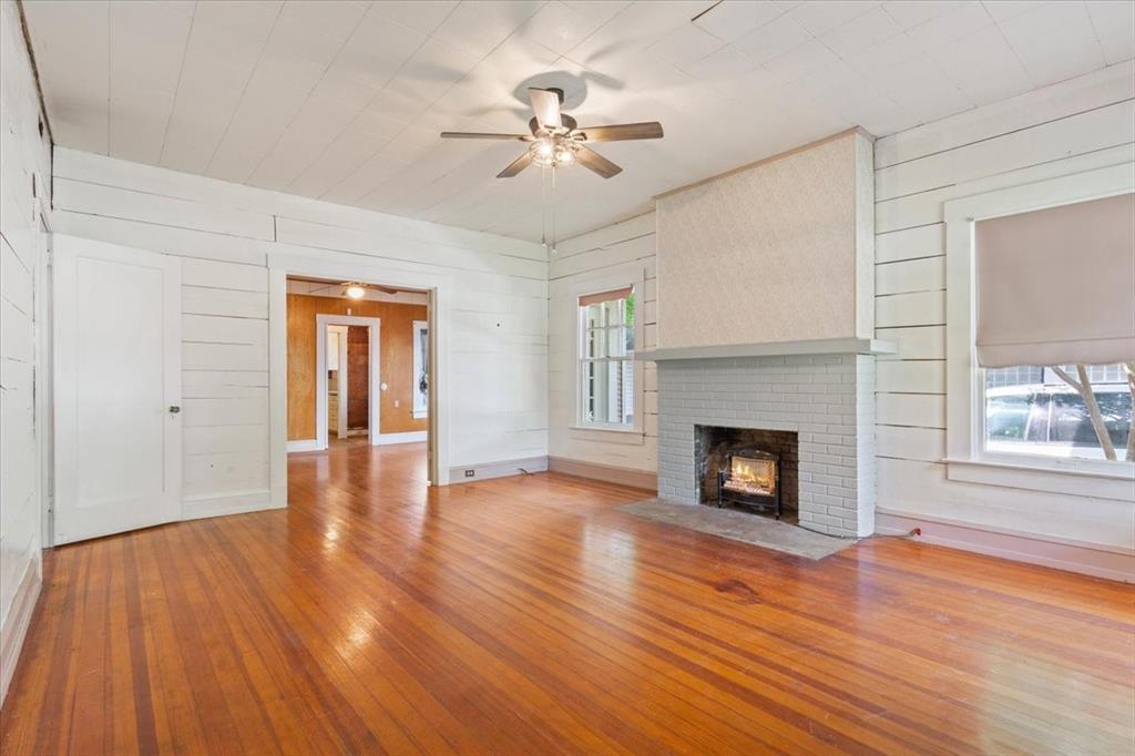 2600 Colcord Avenue Waco, TX 76707 - Photo 6 of 37 a view of a livingroom with wooden floor and a fireplace