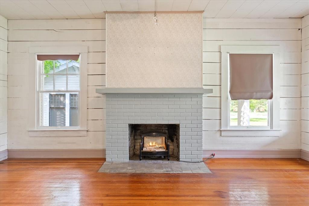 2600 Colcord Avenue Waco, TX 76707 - Photo 7 of 37 a view of an empty room with wooden floor and a window