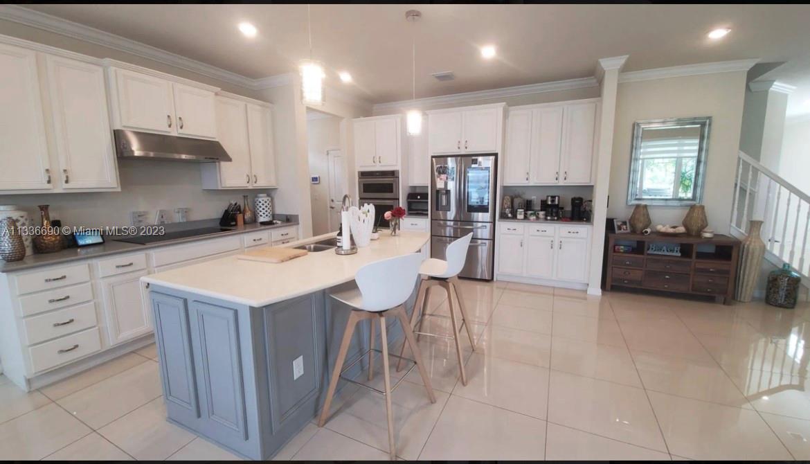 Hillcrest Hollywood, FL 33021 - Photo 11 of 30 a kitchen with stainless steel appliances kitchen island granite countertop a sink and cabinets