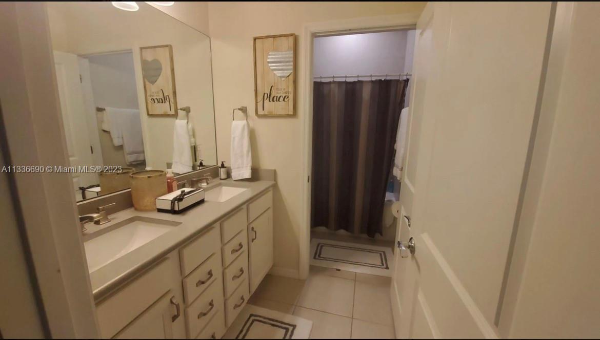 Hillcrest Hollywood, FL 33021 - Photo 18 of 30 a bathroom with a sink and a mirror