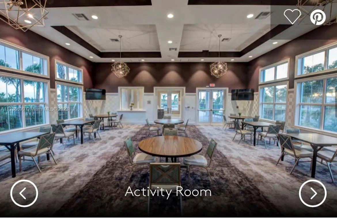 Hillcrest Hollywood, FL 33021 - Photo 26 of 30 a dining room with furniture and a floor to ceiling window