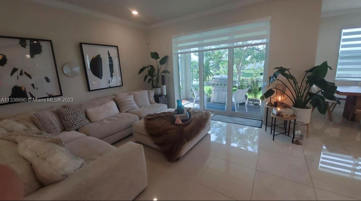 Hillcrest Hollywood, FL 33021 - Photo 6 of 30 a living room with furniture and a floor to ceiling window