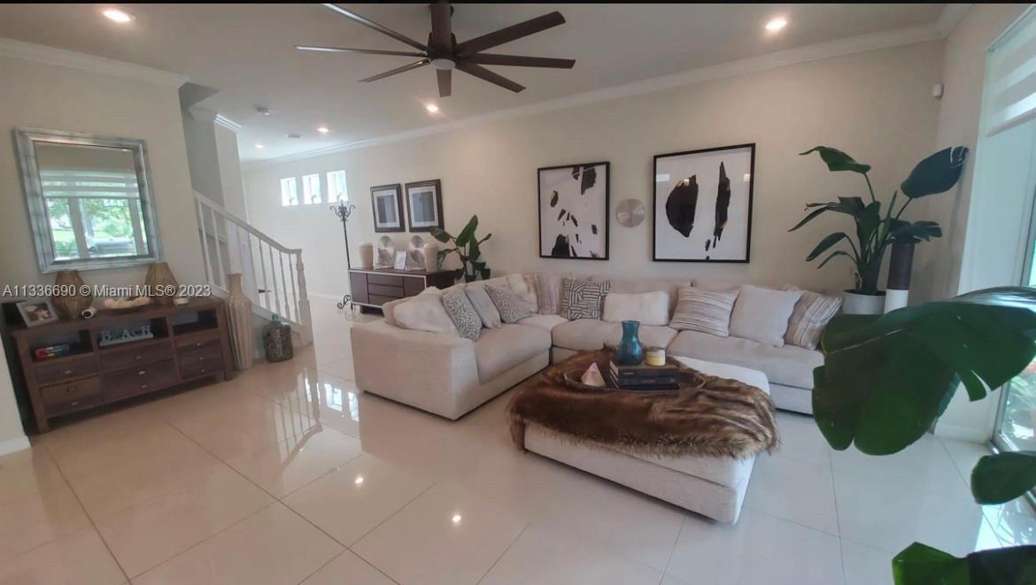 Hillcrest Hollywood, FL 33021 - Photo 8 of 30 a living room with furniture and a chandelier