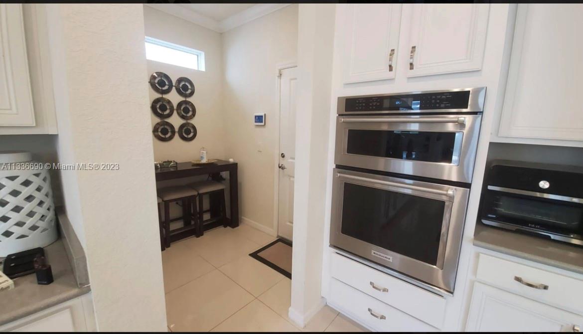 Hillcrest Hollywood, FL 33021 - Photo 10 of 30 a kitchen with cabinets and steel appliances