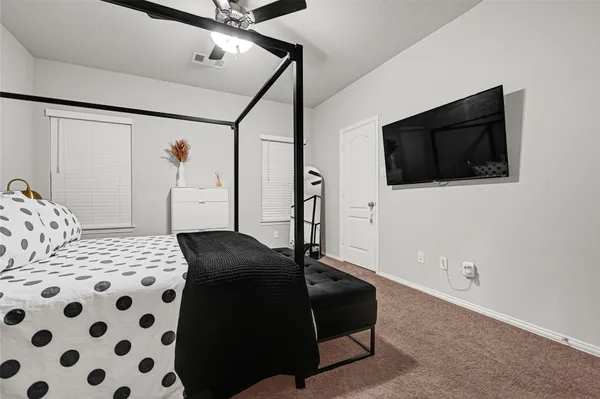 a bedroom with a bed and a television