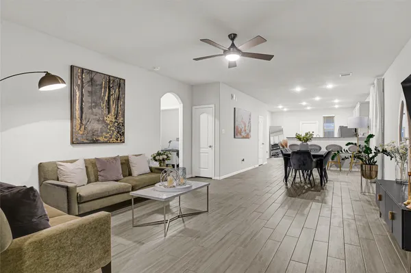 a living room with furniture and a wooden floor