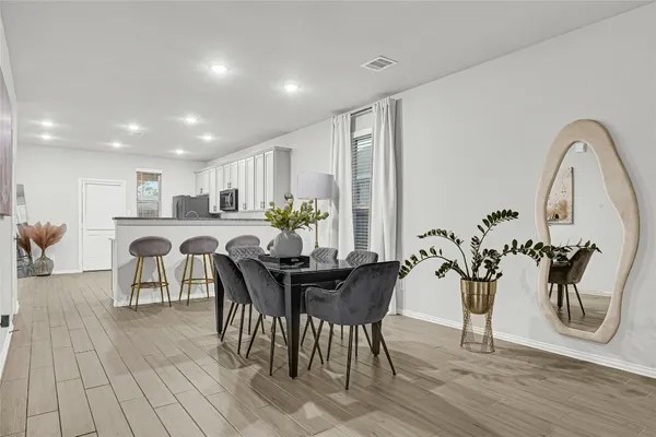 a view of a dining room with furniture and wooden floor