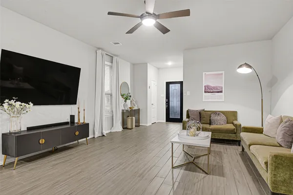 a living room with furniture and a flat screen tv