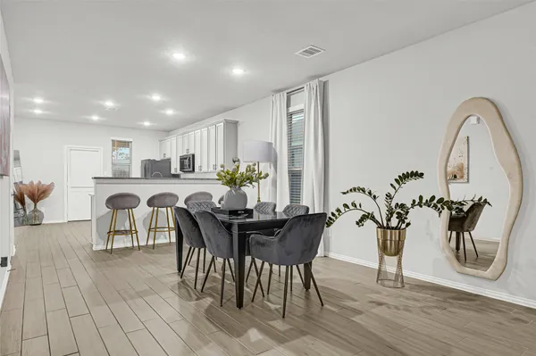 a view of a dining room with furniture and wooden floor