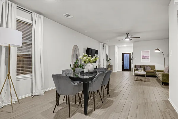 a view of a dining room with furniture and wooden floor