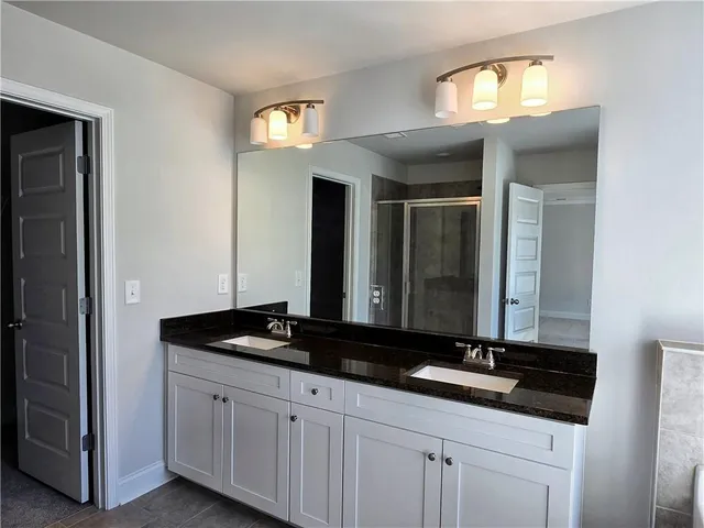 a bathroom with a glass shower door