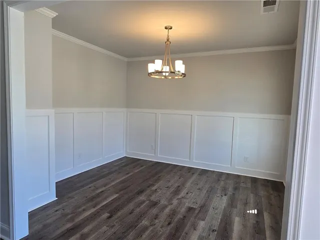 a kitchen with stainless steel appliances granite countertop a sink a microwave a stove a refrigerator and island