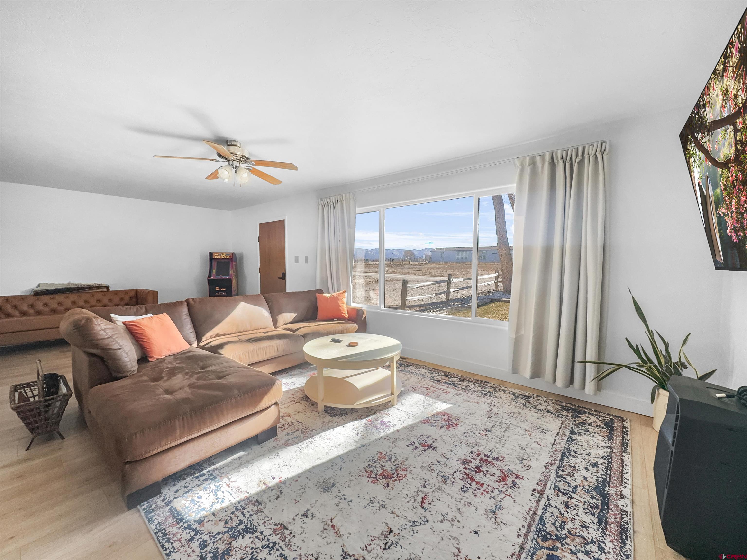 10880 Road 26 Cortez, CO 81321 - Photo 12 of 43 a living room with furniture and a large window