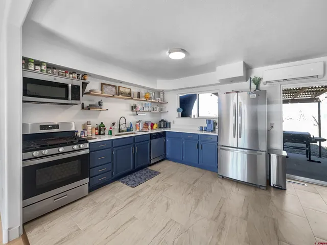 a kitchen with stainless steel appliances granite countertop a refrigerator stove and microwave