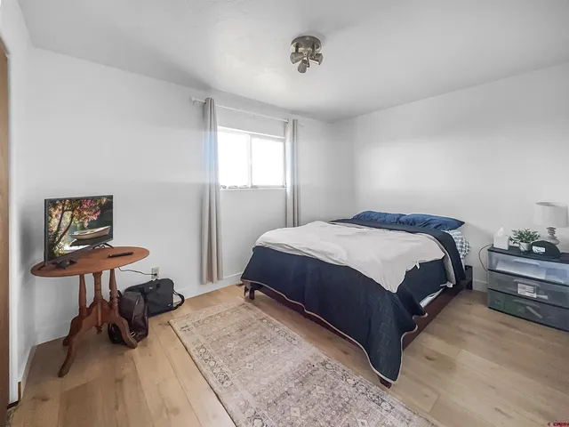 a bedroom with a bed a table and chair