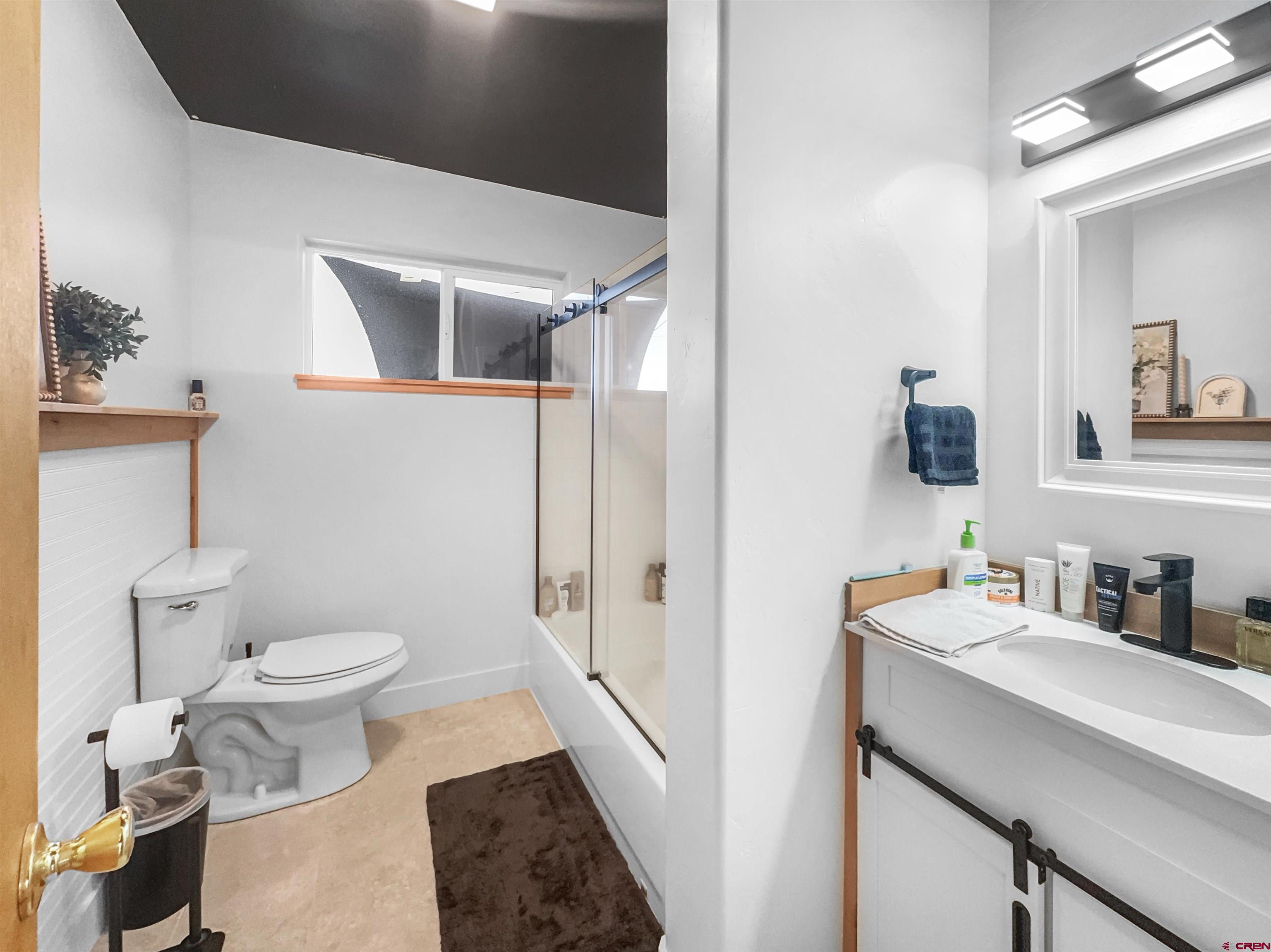 10880 Road 26 Cortez, CO 81321 - Photo 16 of 43 a bathroom with a sink toilet and shower