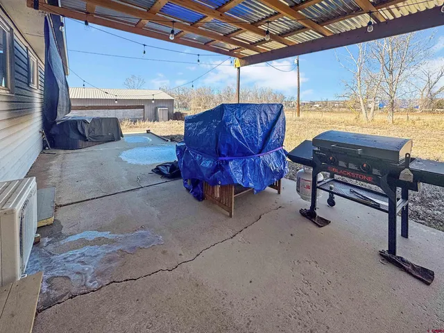 a building outdoor space with patio furniture and potted plants