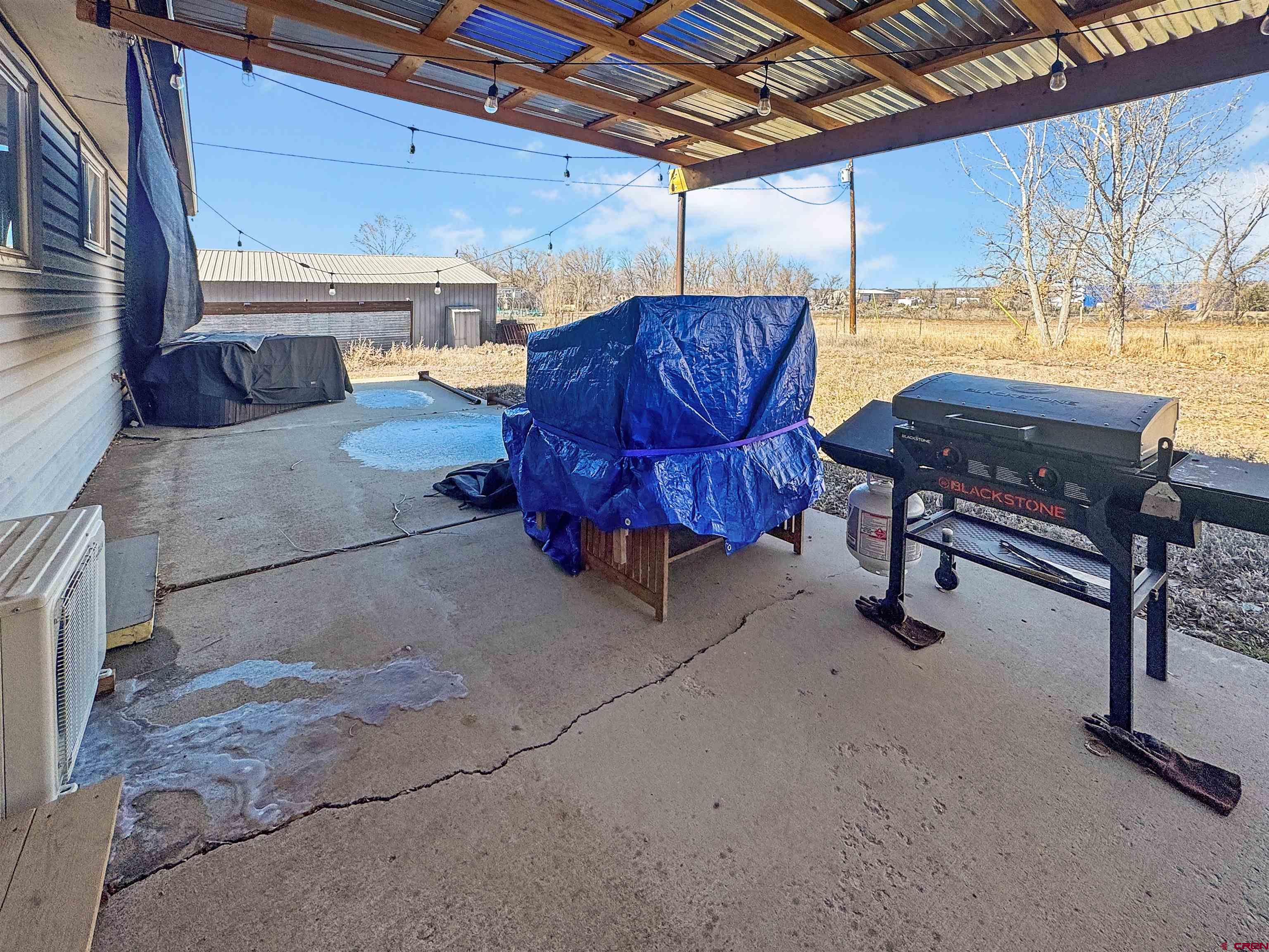 10880 Road 26 Cortez, CO 81321 - Photo 18 of 43 a building outdoor space with patio furniture and potted plants