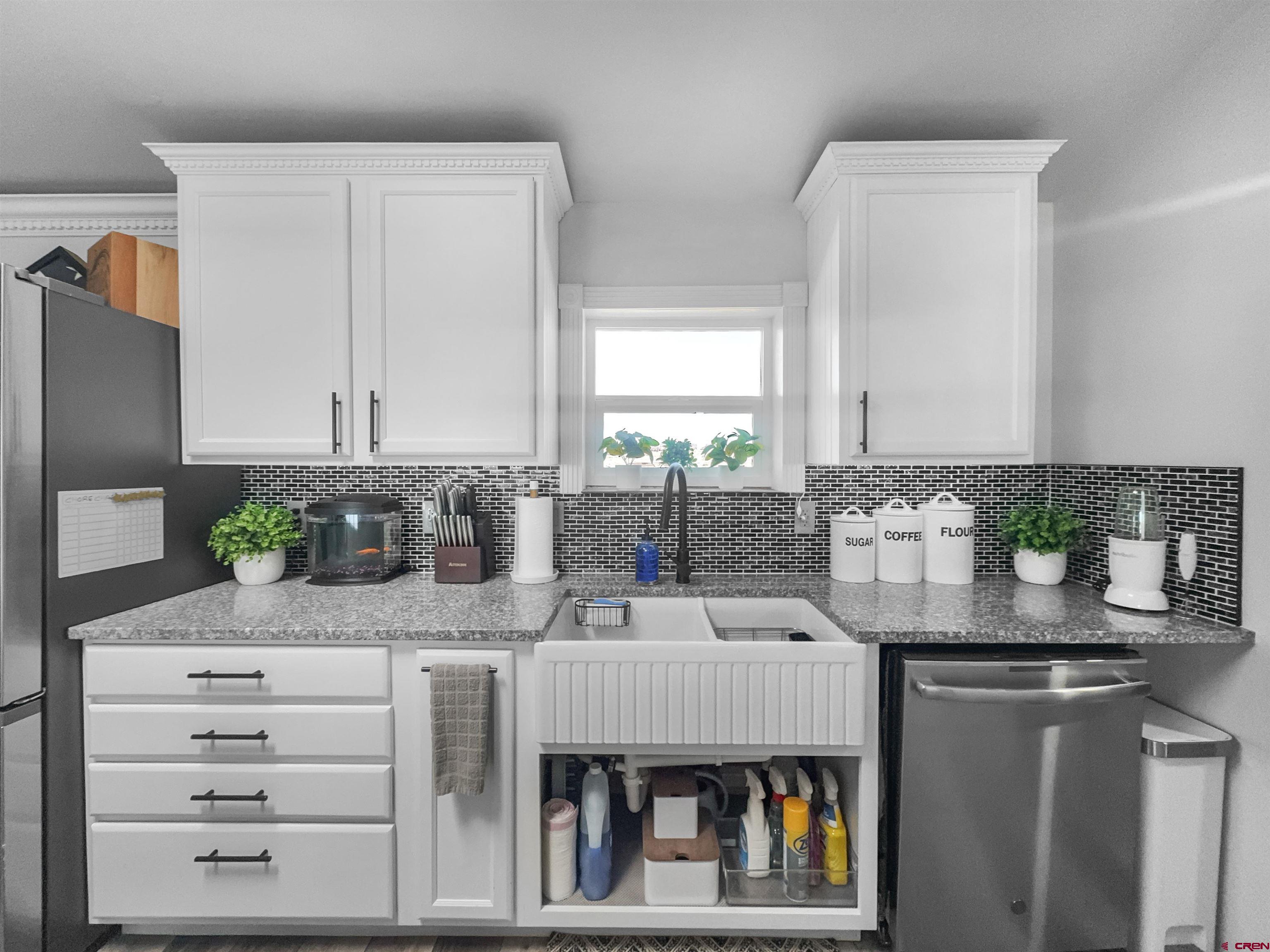 10880 Road 26 Cortez, CO 81321 - Photo 26 of 43 a kitchen with stainless steel appliances kitchen island granite countertop a refrigerator and a counter space