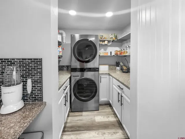 a utility room with sink dryer and washer